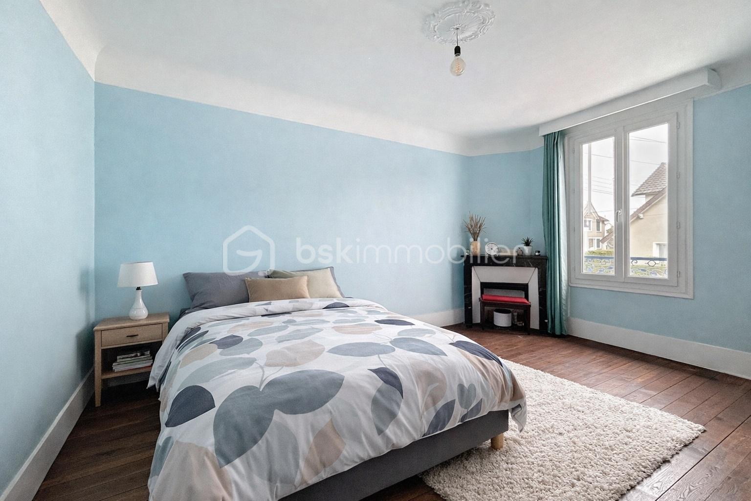 Maison de 100 m² - Chambre moderne aux tons doux et naturels.jpg