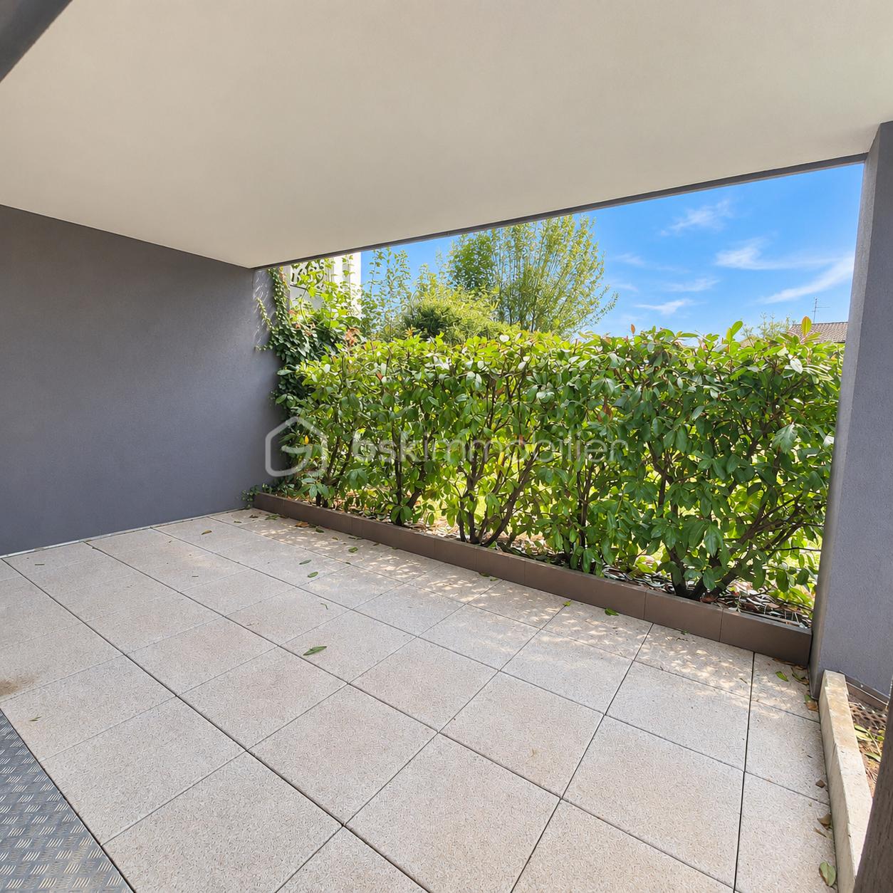 Sunny Modern Terrace Overlooking a Lush Garden.png