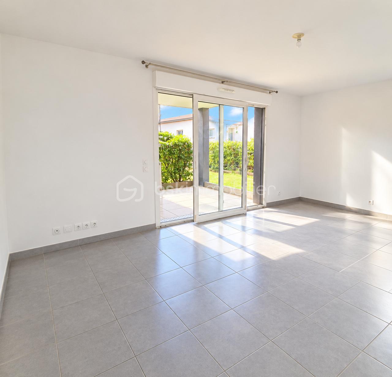Sunlit Empty Living Room with Patio Views.png