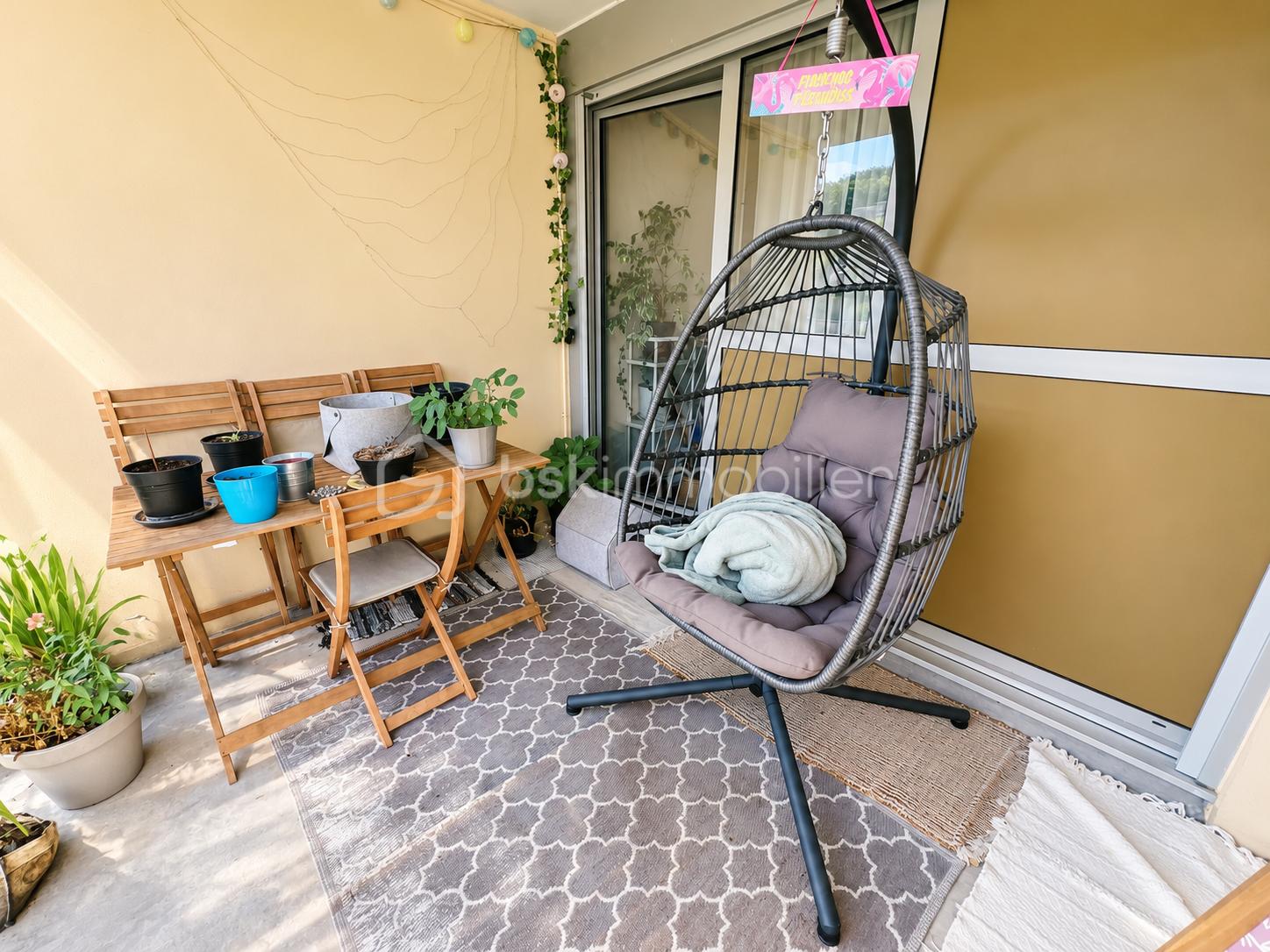 Balcon fleuri et fauteuil suspendu.png