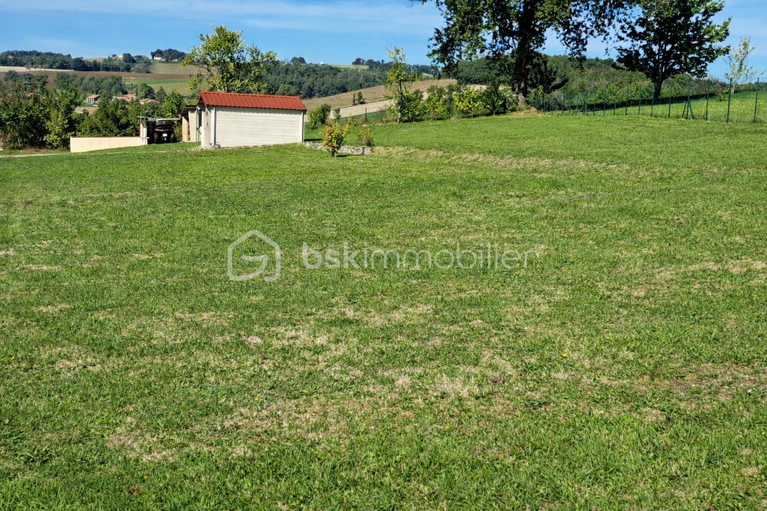 Maison de 70 m² - Paysage rural ensoleillé avec garage.png
