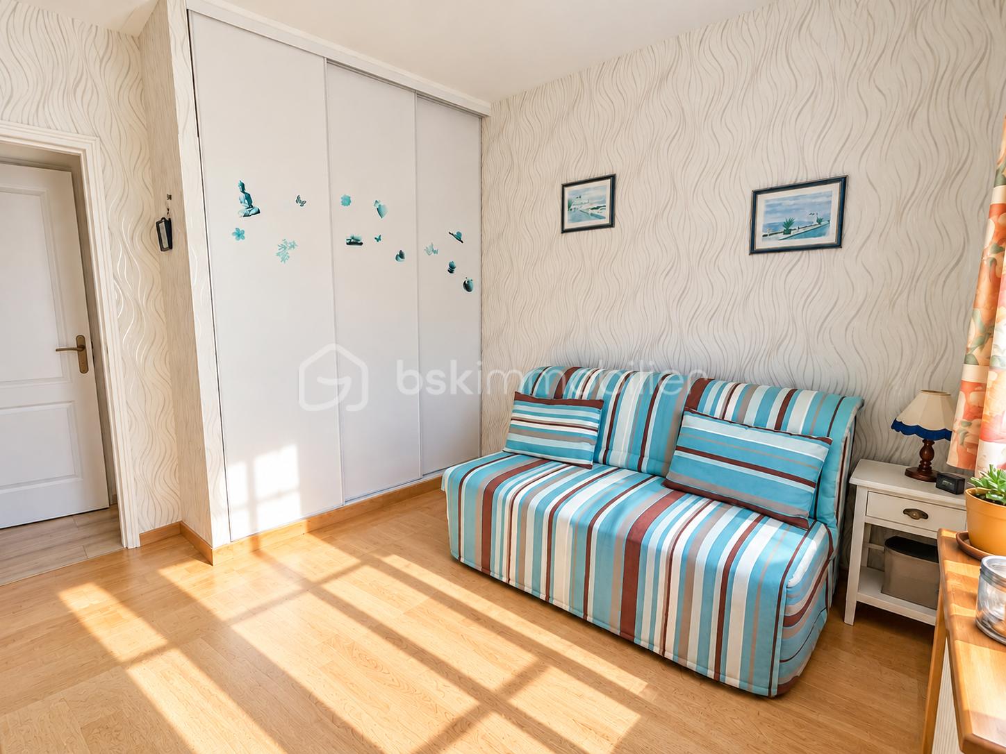 Sunlit Coastal Room with Striped Sofa.png