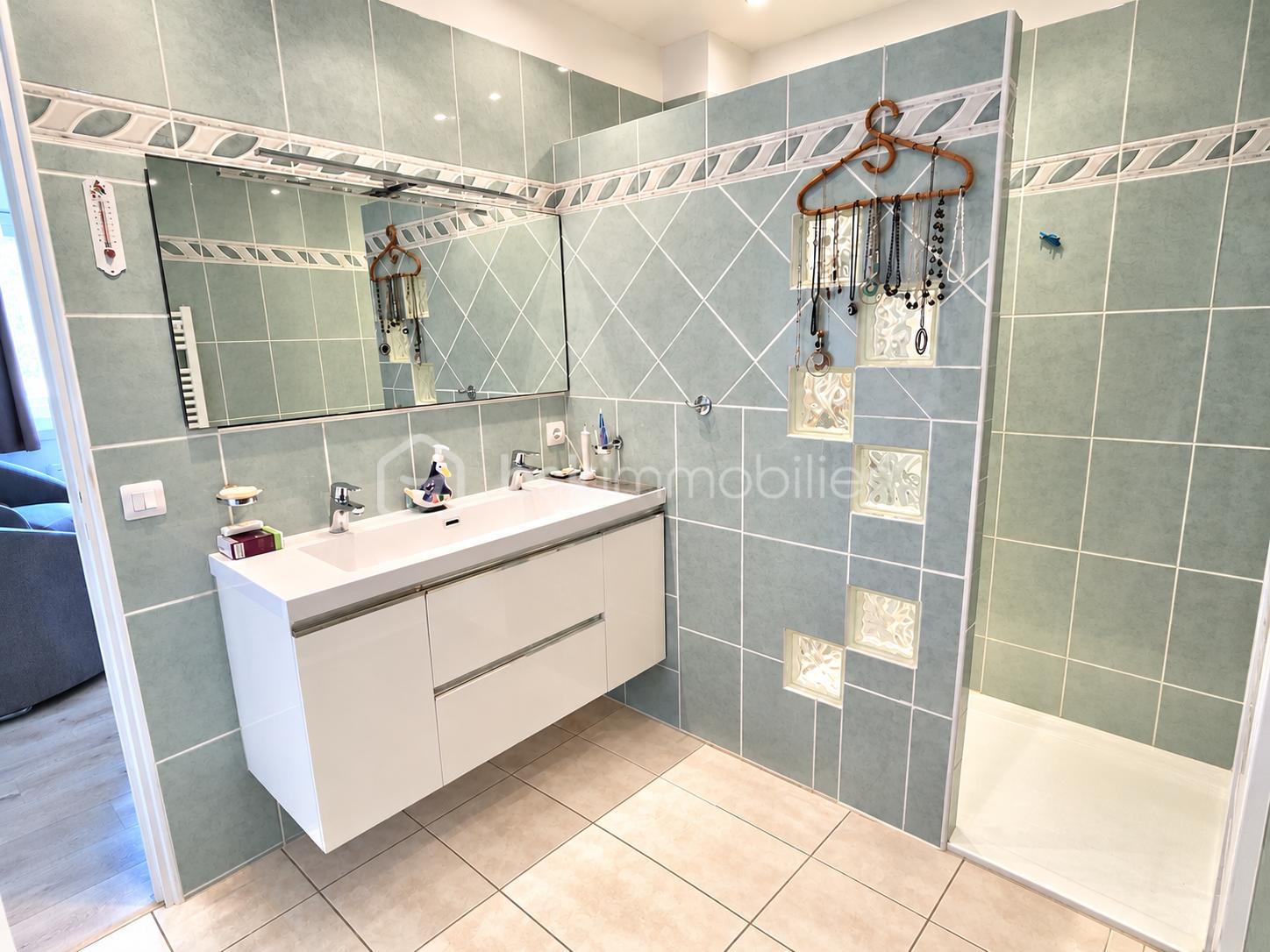 Modern Green-Tiled Bathroom Without Mats.png