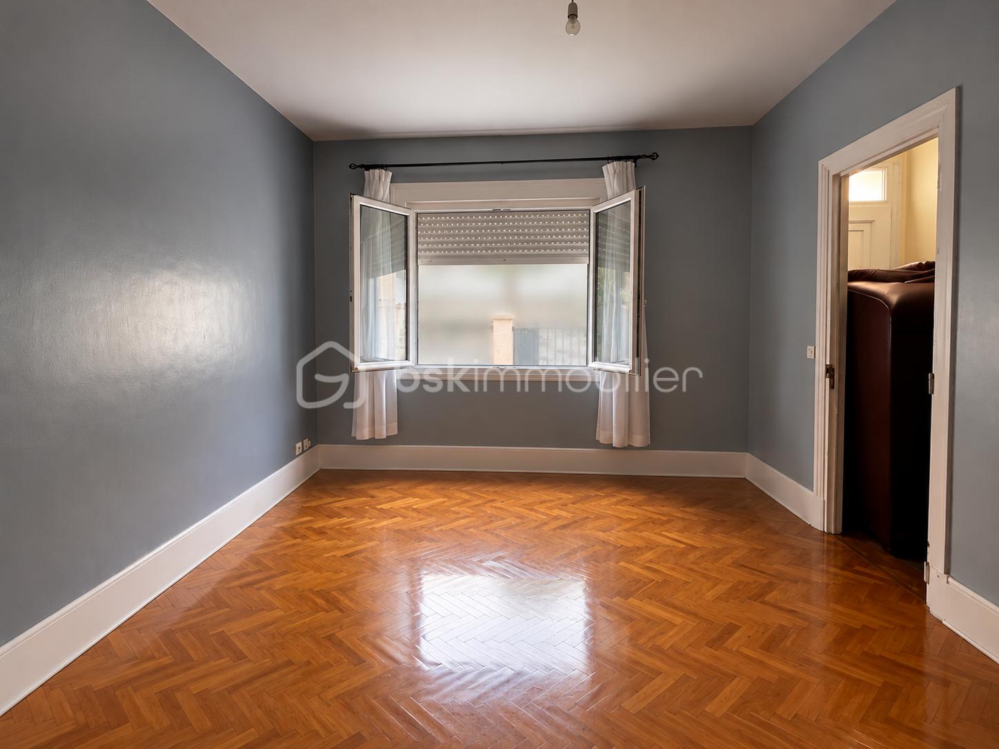 Pièce vide avec fenêtre ouverte et parquet en chevrons.png