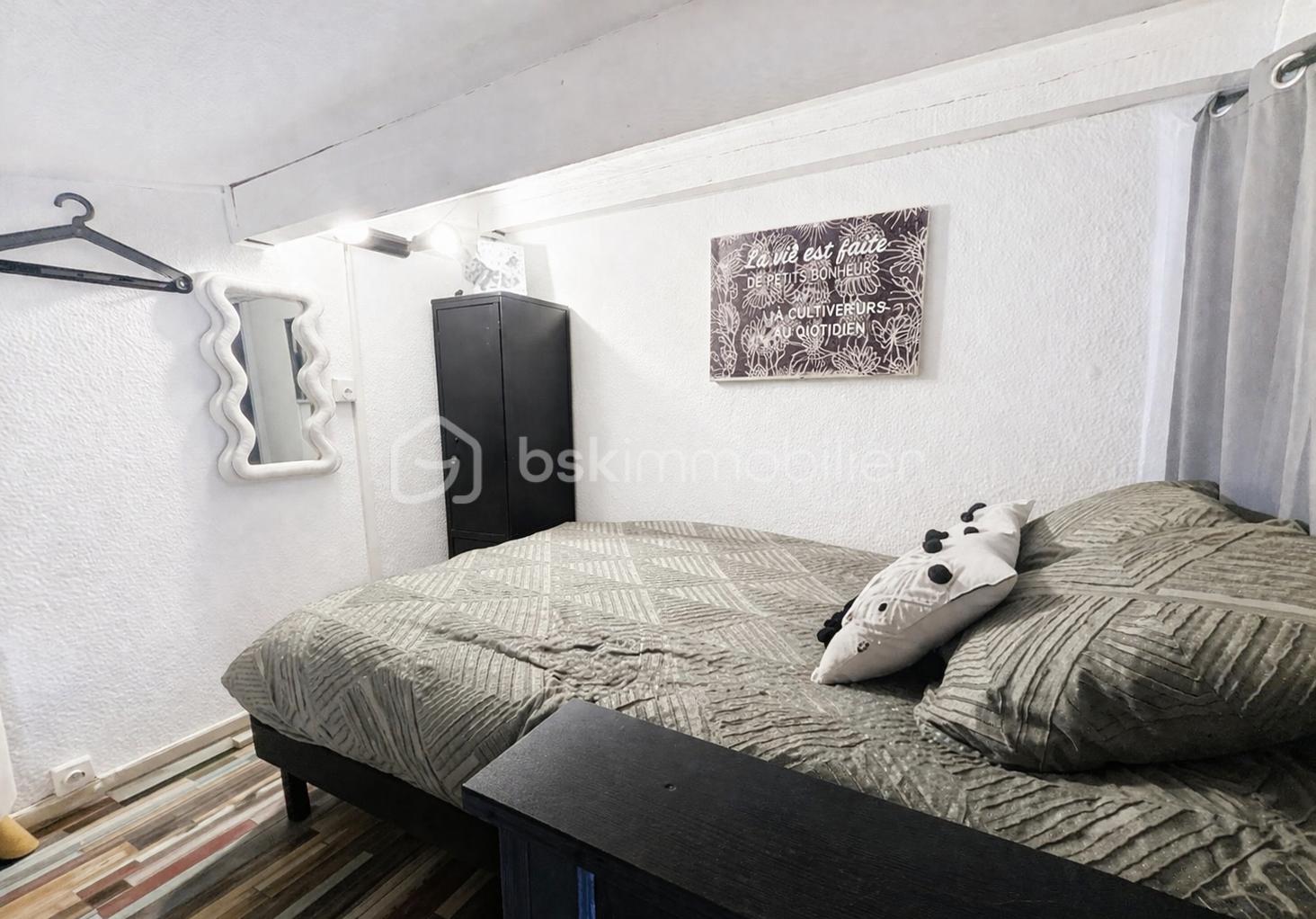 Cozy minimalist bedroom with geometric bedding.png