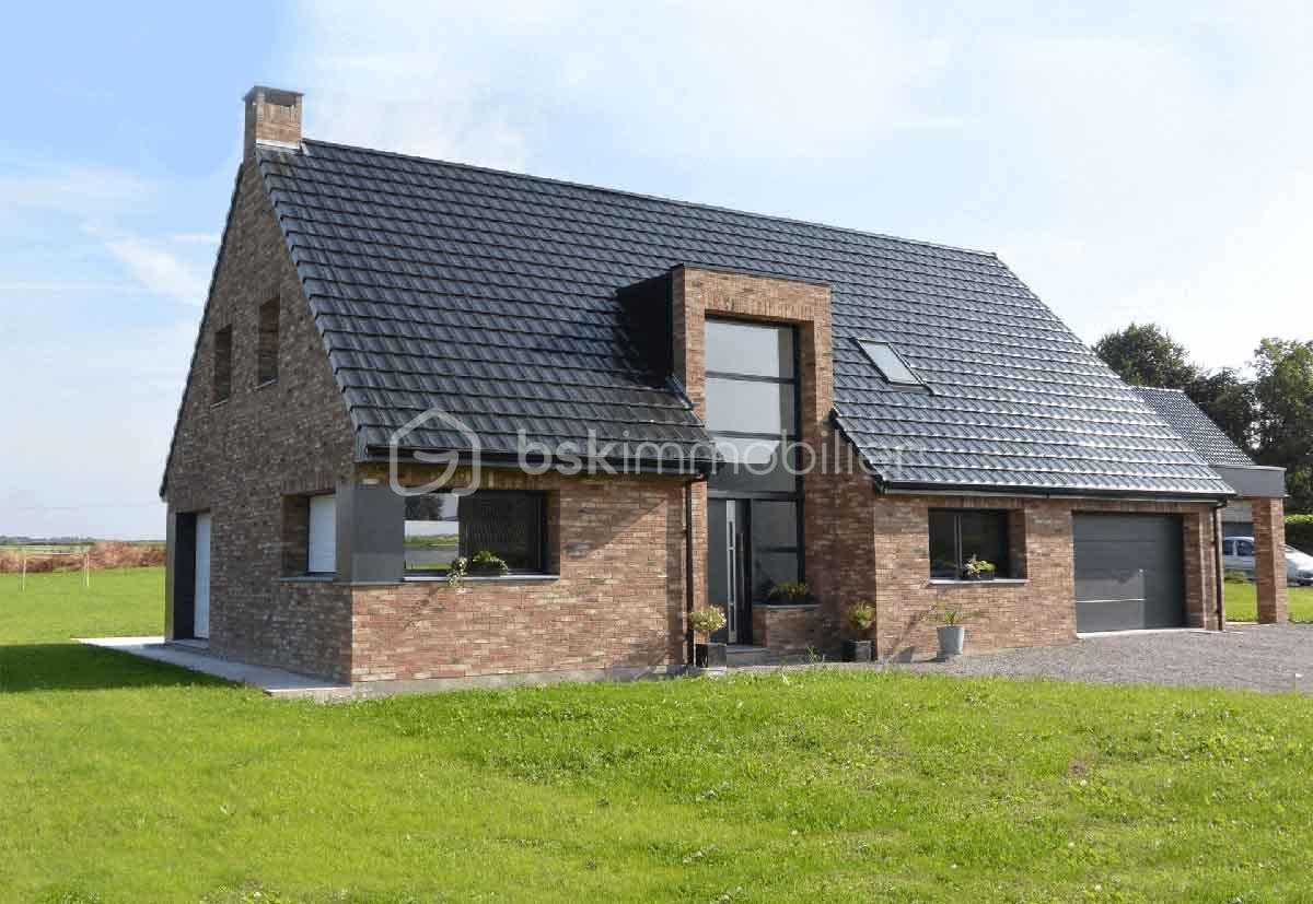 Terrain de 1 000 m² - boulin maison brique toit noir et verrière.png