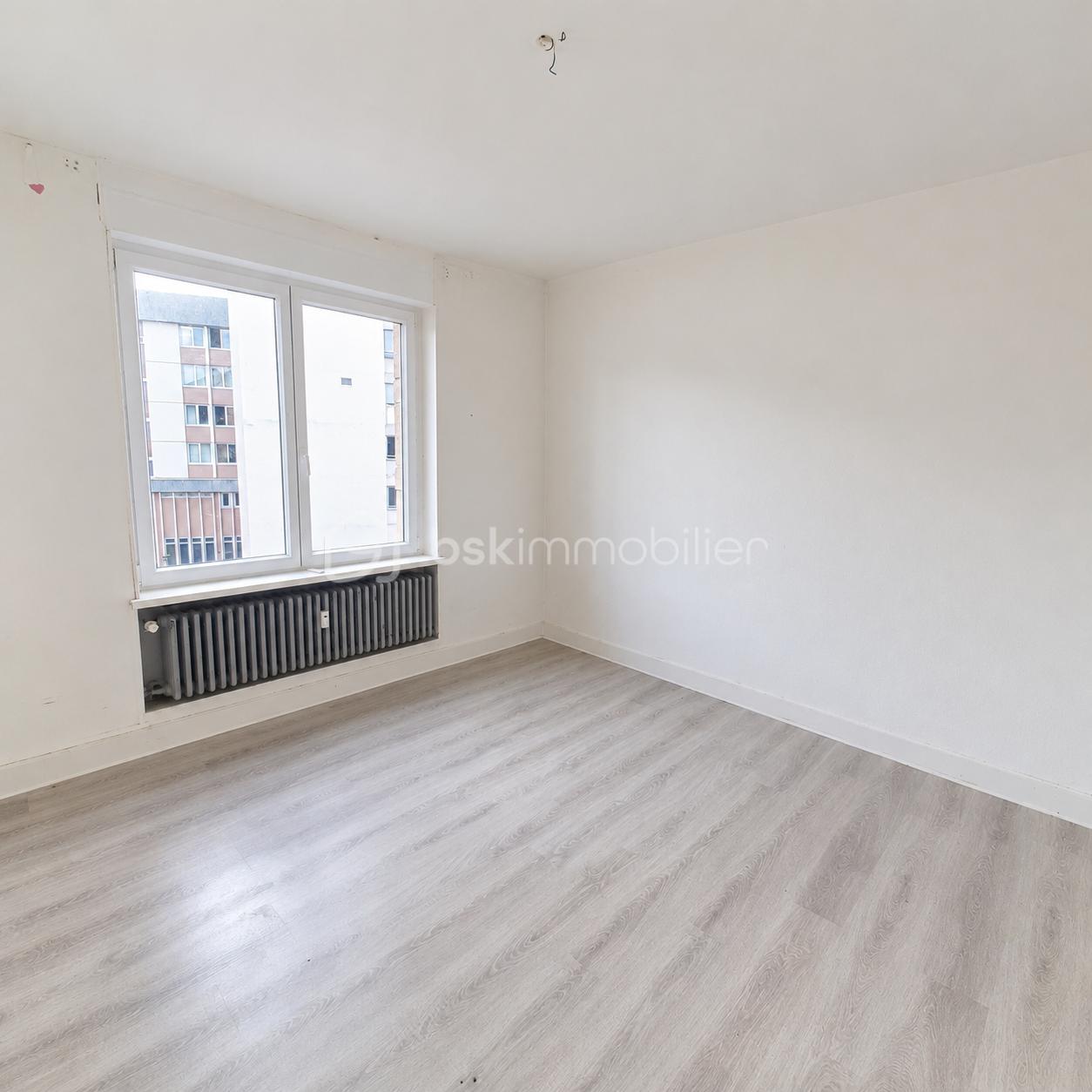 Bright Empty Room with Urban Window View.png