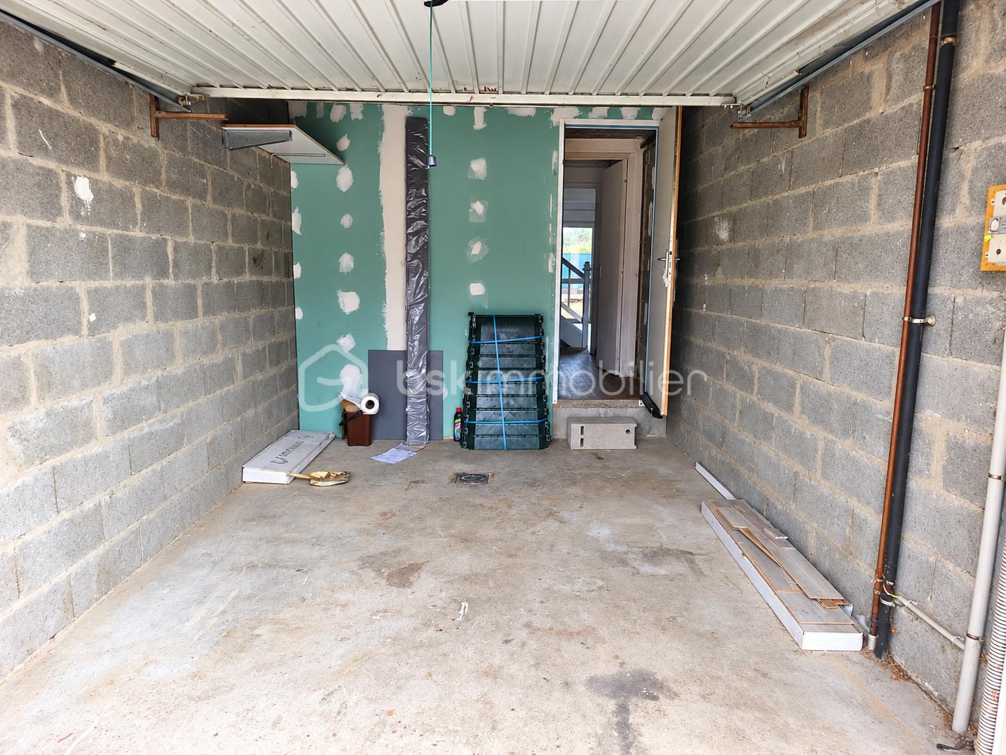 Garage en rénovation avec matériaux de construction.png
