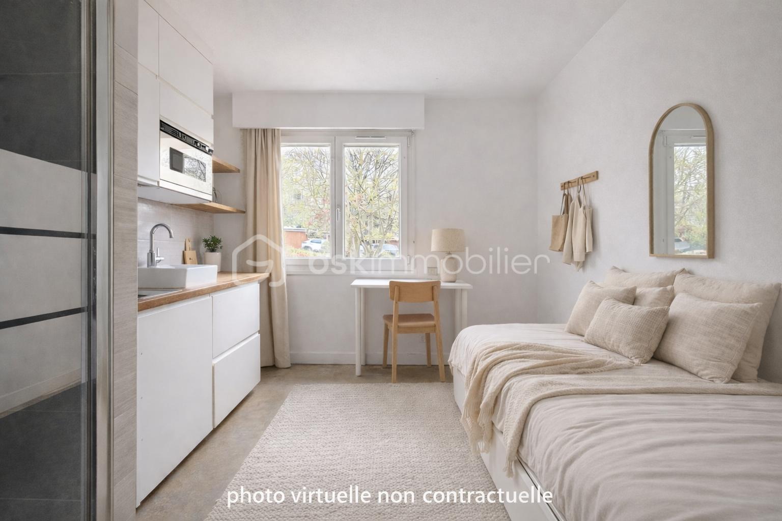 Chambre minimaliste avec kitchenette et bureau.png